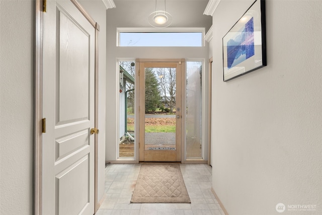 foyer entrance featuring crown molding