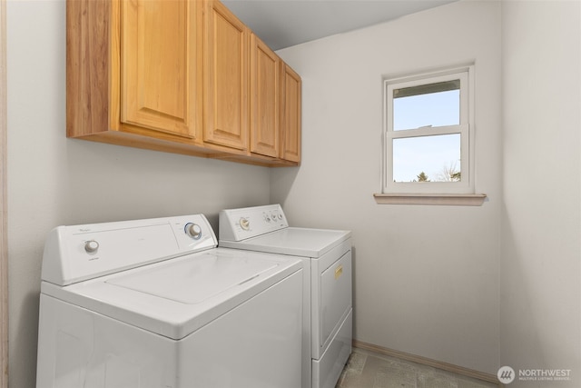 laundry room with washing machine and dryer and cabinet space