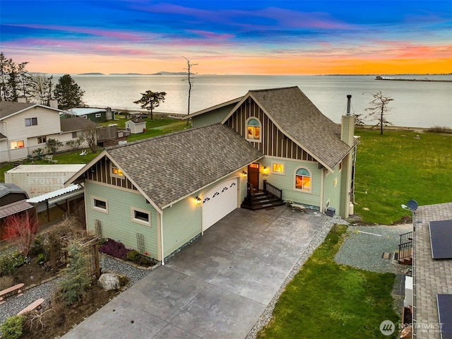 view of front of property with a garage, concrete driveway, roof with shingles, and board and batten siding