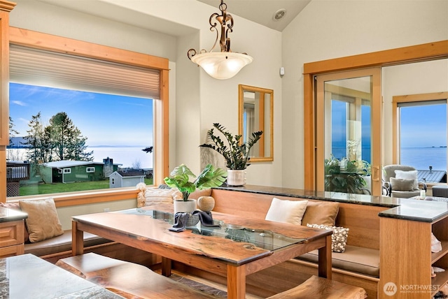 dining area with breakfast area and lofted ceiling