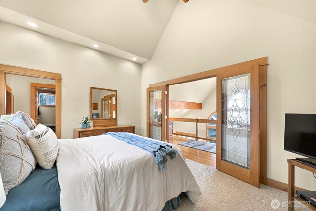 carpeted bedroom with high vaulted ceiling, recessed lighting, and baseboards