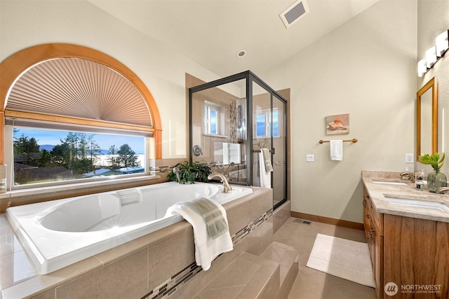 full bath with double vanity, a sink, a bath, and a shower stall