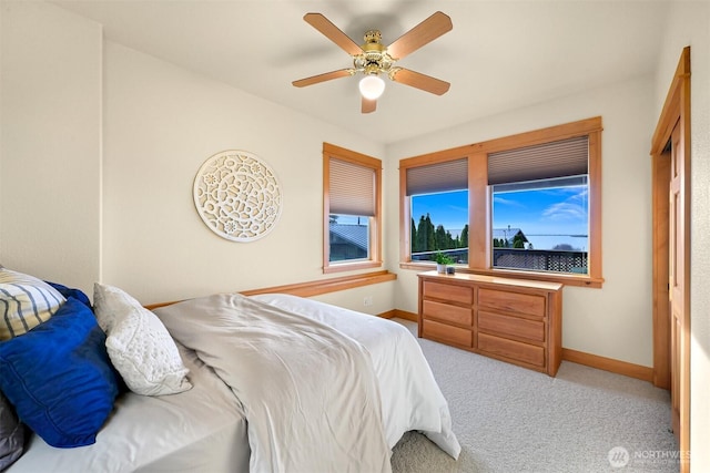 carpeted bedroom featuring ceiling fan and baseboards