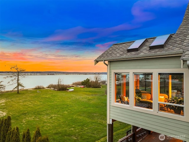 yard at dusk with a water view