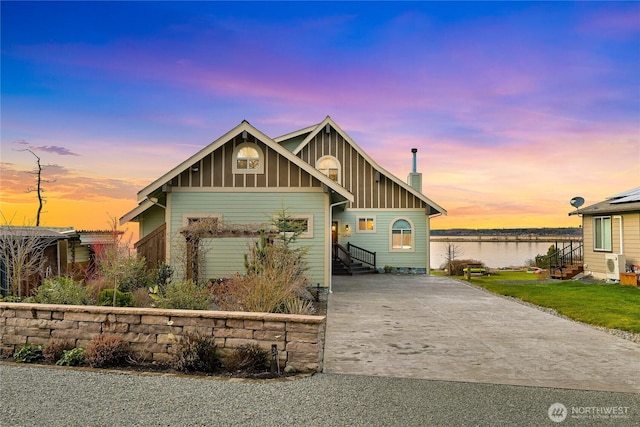 3451 Robertson Rd, Bellingham, WA 98226 - view of front of property featuring driveway, board and batten siding, a water view, a chimney, and entry steps