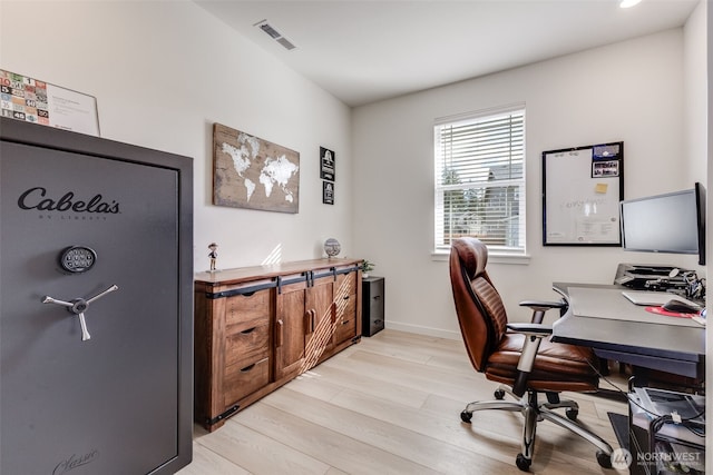 office area featuring baseboards, visible vents, and light wood finished floors