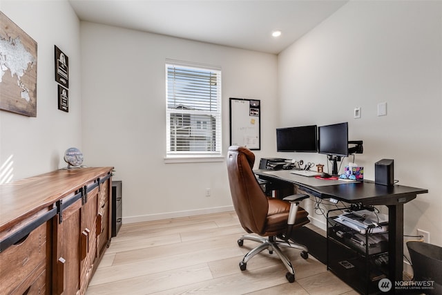 office space with light wood-type flooring, baseboards, and recessed lighting