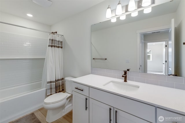 full bathroom featuring toilet, shower / tub combo, backsplash, and vanity