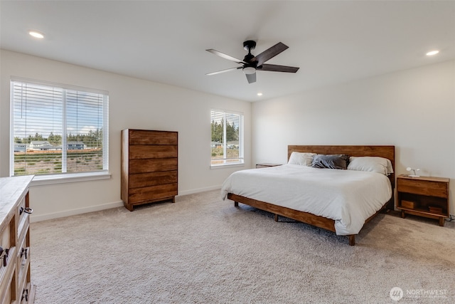 bedroom featuring light carpet, recessed lighting, and baseboards