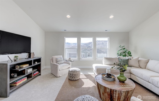 carpeted living area with recessed lighting, visible vents, and baseboards