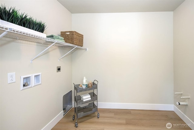 clothes washing area featuring baseboards, washer hookup, laundry area, wood finished floors, and electric dryer hookup