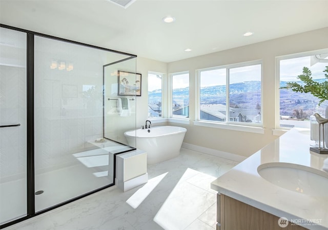 bathroom featuring a shower stall, recessed lighting, marble finish floor, and a freestanding bath