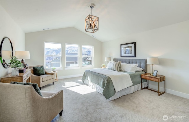 bedroom featuring lofted ceiling, visible vents, baseboards, and light carpet