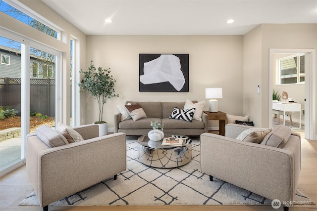 living area with light wood-type flooring and recessed lighting