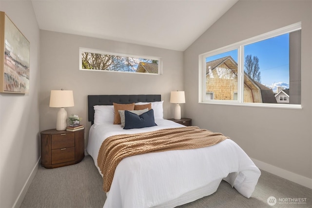 carpeted bedroom featuring lofted ceiling and baseboards