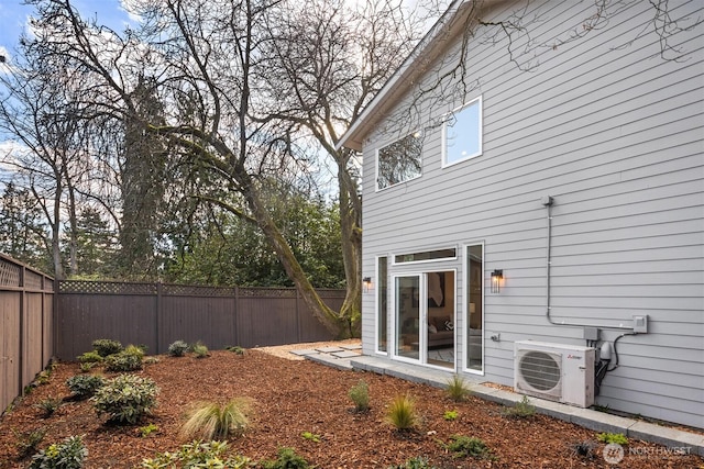 back of house with ac unit and a fenced backyard