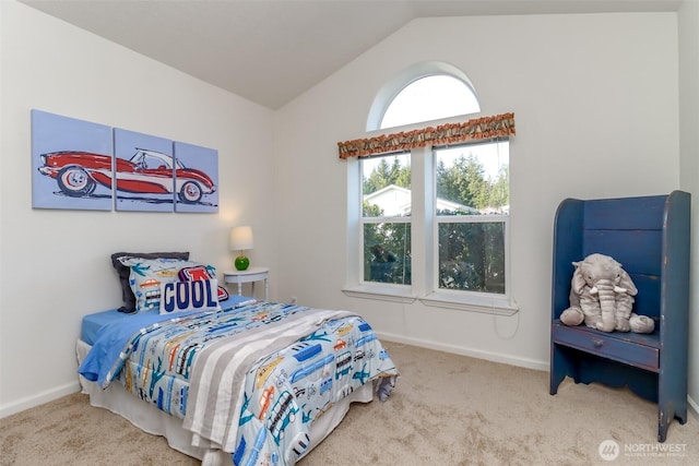 carpeted bedroom with lofted ceiling and baseboards