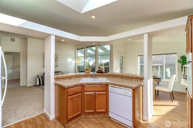 kitchen with visible vents, dishwasher, open floor plan, a sink, and recessed lighting