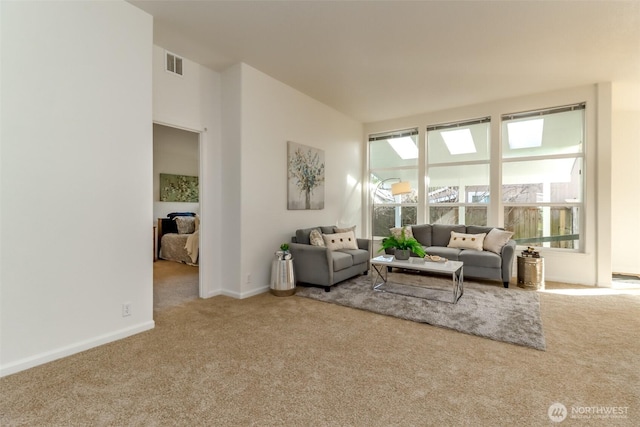 living room with carpet floors, visible vents, and baseboards