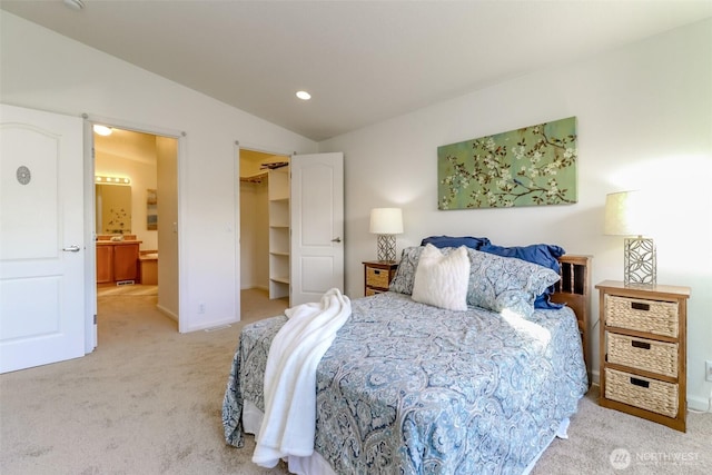 bedroom featuring recessed lighting, light carpet, baseboards, vaulted ceiling, and a spacious closet