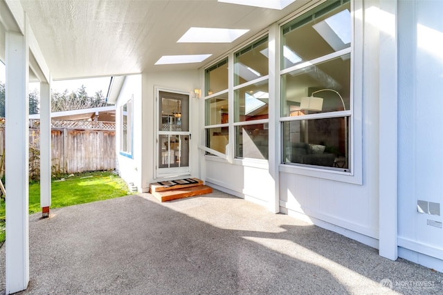 doorway to property featuring fence and a patio