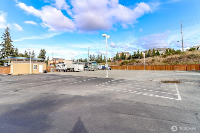 uncovered parking lot with fence