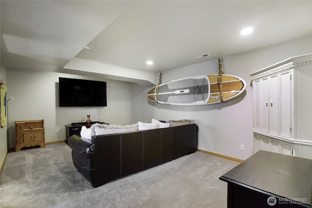 carpeted living area with recessed lighting, visible vents, and baseboards