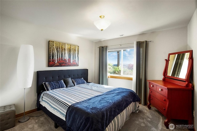 bedroom featuring visible vents, baseboards, and carpet