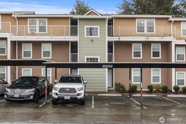 view of building exterior with covered parking