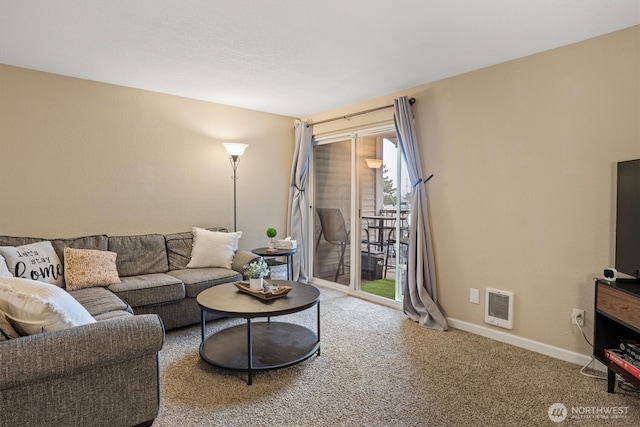 carpeted living room featuring visible vents and baseboards