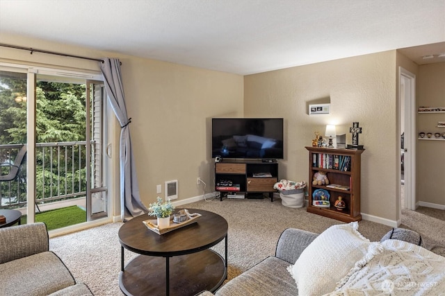 living room with visible vents, baseboards, a wealth of natural light, and carpet flooring