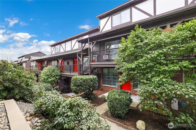 exterior space with stairway and brick siding