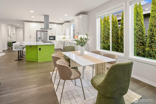 dining space with baseboards, recessed lighting, and light wood-style floors