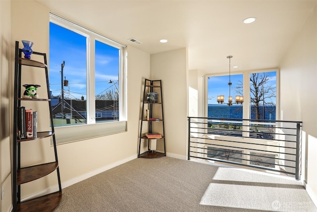 interior space featuring a chandelier, recessed lighting, carpet flooring, visible vents, and baseboards