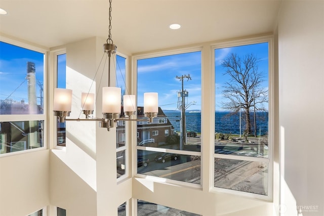 entryway featuring a water view and recessed lighting