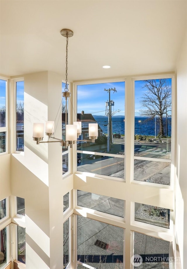 room details featuring a water view and an inviting chandelier