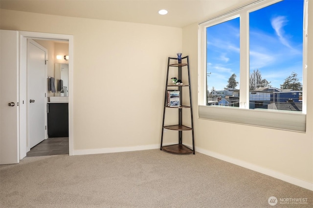 spare room featuring recessed lighting, carpet flooring, and baseboards