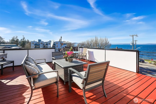 deck with a water view and outdoor lounge area