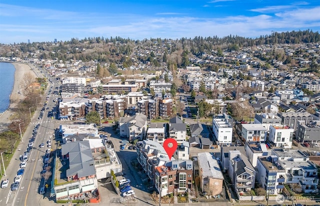 drone / aerial view featuring a residential view and a water view