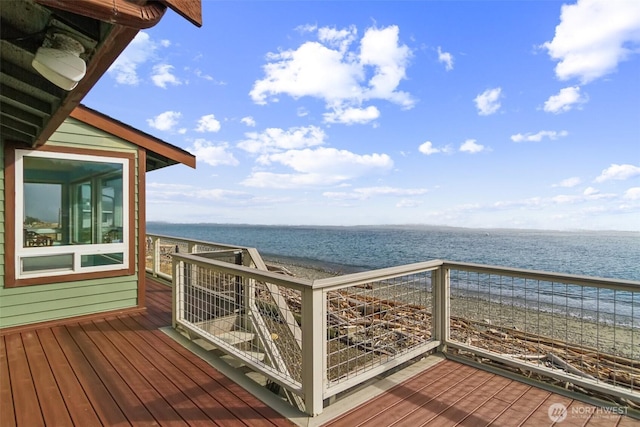 deck with a beach view and a water view