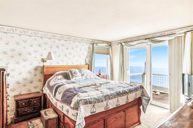 bedroom featuring light carpet, access to exterior, and wallpapered walls