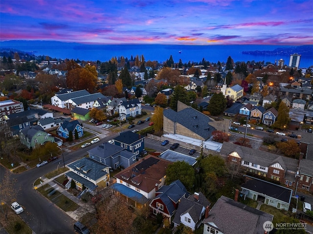 birds eye view of property featuring a water view and a residential view