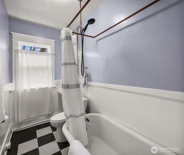 bathroom with toilet and tile patterned floors