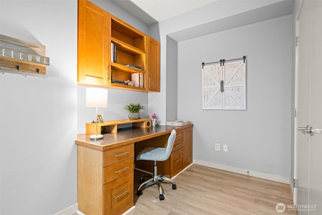 office area featuring light wood-style flooring and baseboards