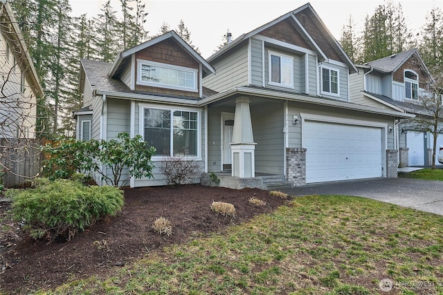 craftsman inspired home featuring an attached garage and driveway