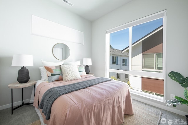 carpeted bedroom with baseboards and visible vents