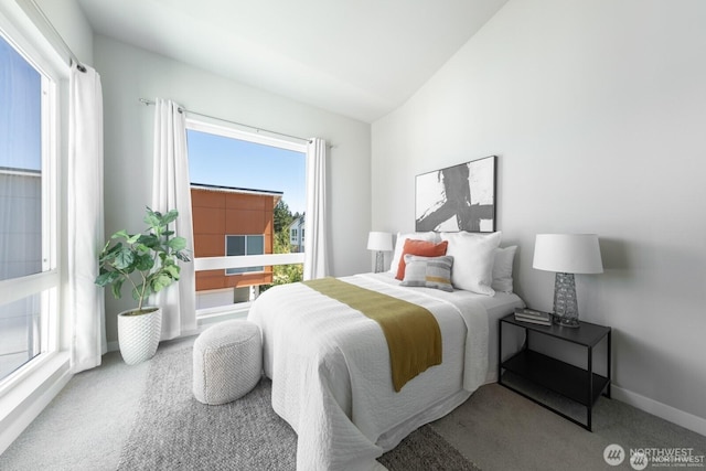 bedroom featuring lofted ceiling, carpet floors, and baseboards