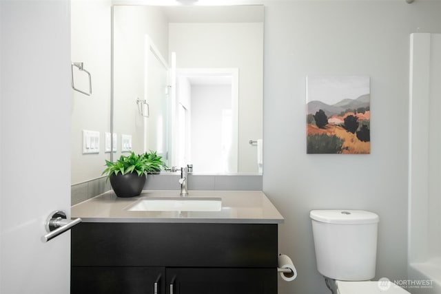 bathroom featuring vanity and toilet