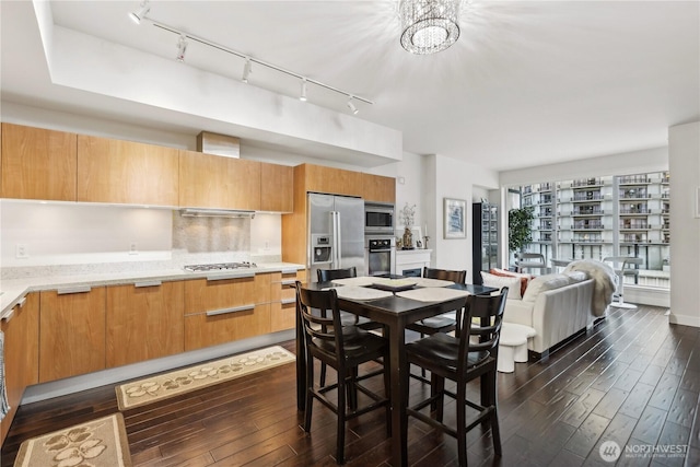 dining space with dark wood-style flooring