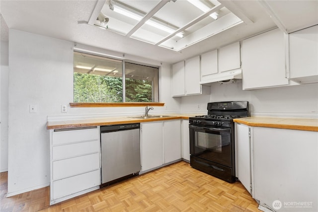 kitchen with under cabinet range hood, gas stove, white cabinets, wooden counters, and dishwasher